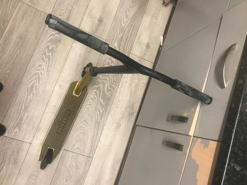 Golden and black push - , scooter